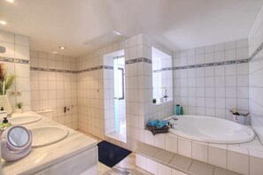 A bathroom with two sinks, a bathtub, and a mirror. - Beachside Apartment With Jacuzzi & Pool (Marbella)