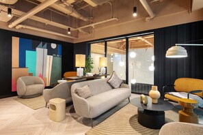 A modern living room with a sofa, armchairs, a coffee table, and a rug. - The Ironworks (Dublin)