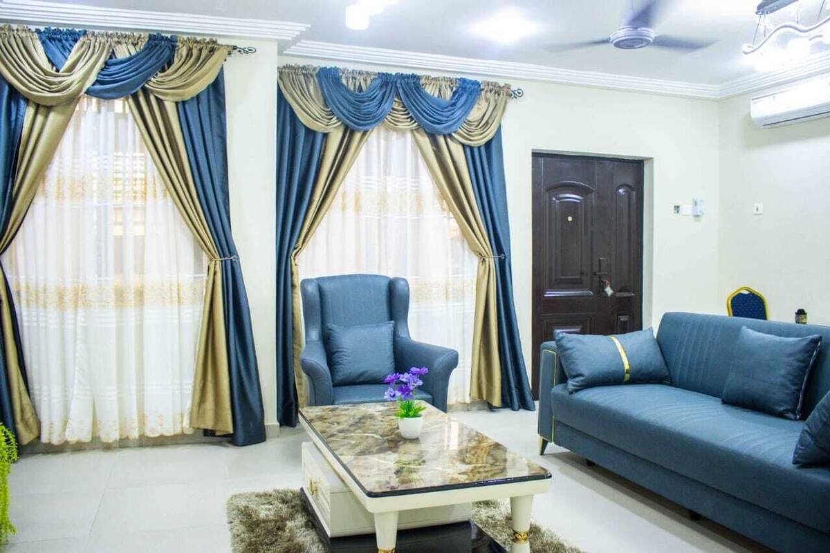 A living room with a sofa, armchair, and coffee table.