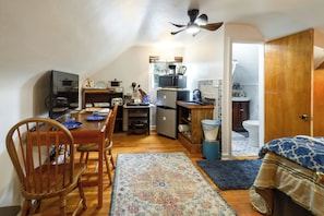 A compact kitchen with a microwave, toaster, and small refrigerator.