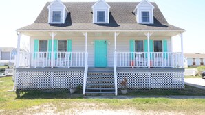 A two-story house with a porch, a front door, and a small balcony. - West Ocean City Vacation House Rental in Quiet Residential Neighborhood (Ocean City)