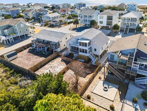 A coastal residential area with houses featuring balconies, a sandy beach, and a clear view of the ocean. - Luna By The Sea / 238 Brunswick Ave West 3 Bedroom Home (Supply)