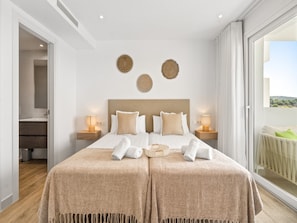A hotel room with a large bed, two bedside tables with lamps, a view of the outdoors, and a balcony. - Alcazaba Lagoon Retreat for 4 (Casares)