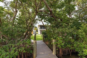Property grounds - Holly's Garden: North end canal front home steps to the beach. (Anna Maria)