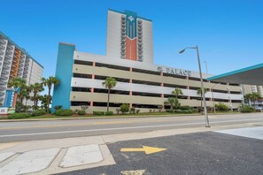 A multi-story parking garage with a prominent sign reading "The PALACE." - Experience Breathtaking Ocean Views (Myrtle Beach)