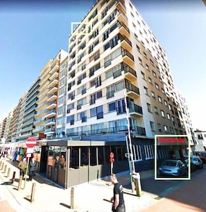 A multi-story residential building with balconies, a visible entrance, and a pedestrian walkway. - Seafront Studio w/Stunning Sea Views (Blankenberge)
