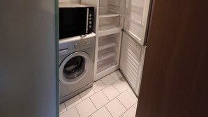 A compact laundry room with a washing machine, a dryer, and a refrigerator. - Country charm (Iviers)