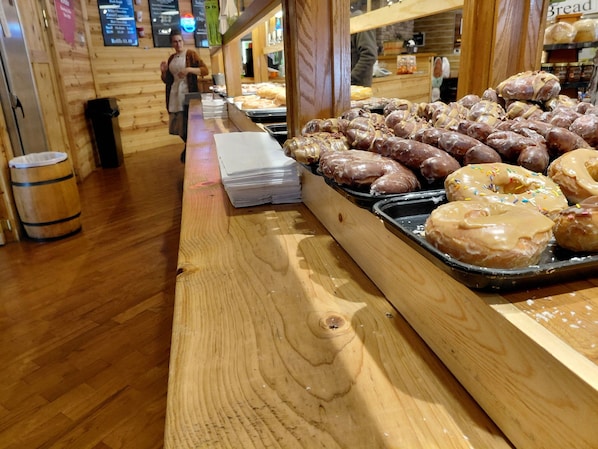 A bakery counter with various donuts and pastries.