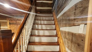 A wooden staircase with white railings and steps, leading to an upper floor. - Whispering Pine's Cabin! NO CHECK-OUT LIST (Patriot)