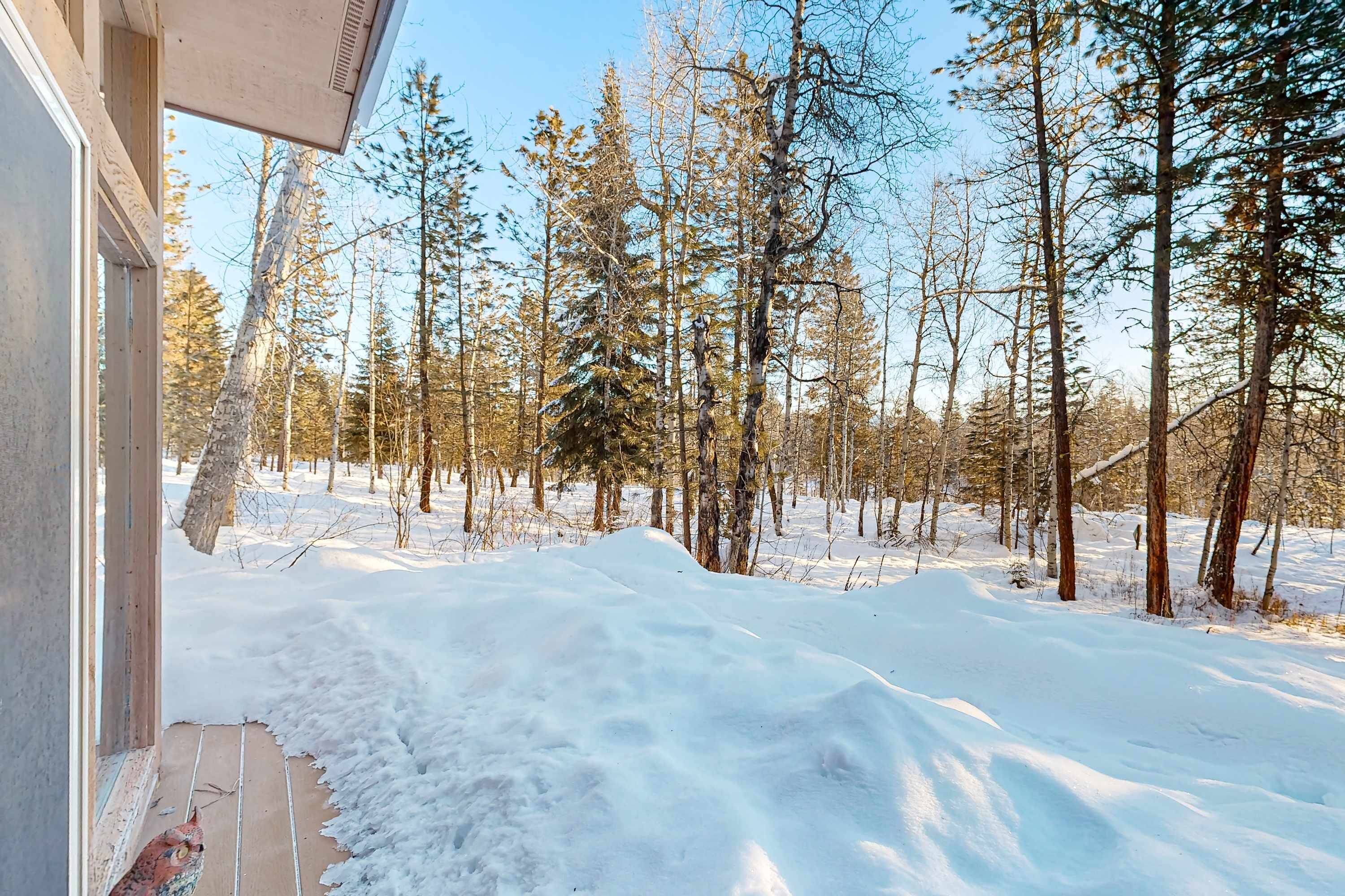 A snowy landscape with a building's exterior and a snow-covered ground.