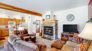 A living room with a fireplace, television, and seating area.