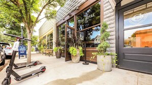 An exterior of a building with a storefront named "The Royal" and a sign indicating it is a certified bakery. - Historic Craftsman Yard, Patio & Fireplace (Boise)