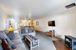 A living room with a sofa, coffee table, and a television on the wall. - McCall Getaway Near Payette Lake & Golf (McCall)