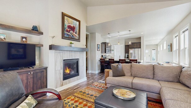 A living room with a fireplace, a television, and a sofa. - Modern McCall Family Retreat, Loft, AC, Deck (McCall)