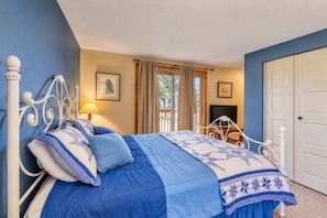 A bedroom with a bed, a television, and a door. - Bogus Basin Ski-In/Ski-Out Condo, Two Decks (Boise)