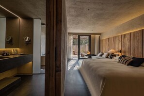 A modern bedroom with a large bed, a bedside table, and a built-in mirror. - Weizhou Island Coral Reef Hotel (Beihai)