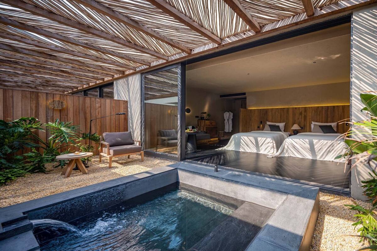 A modern spa area with a hot tub, seating, and a wooden deck.