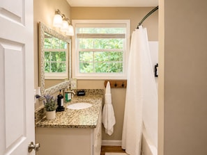 A bathroom with a vanity, a mirror, a window, and a shower curtain. - 5BR Appalachian Retreat Sleeps 13 Fire Pit & String Lights (Washington County)
