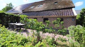 A brick building with a tiled roof and a number '110' sign. - Dalerveen Apartment With Sauna for 7 (Dalerveen)