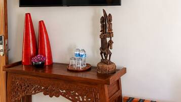 A wooden console table with a flat-screen TV mounted above it.