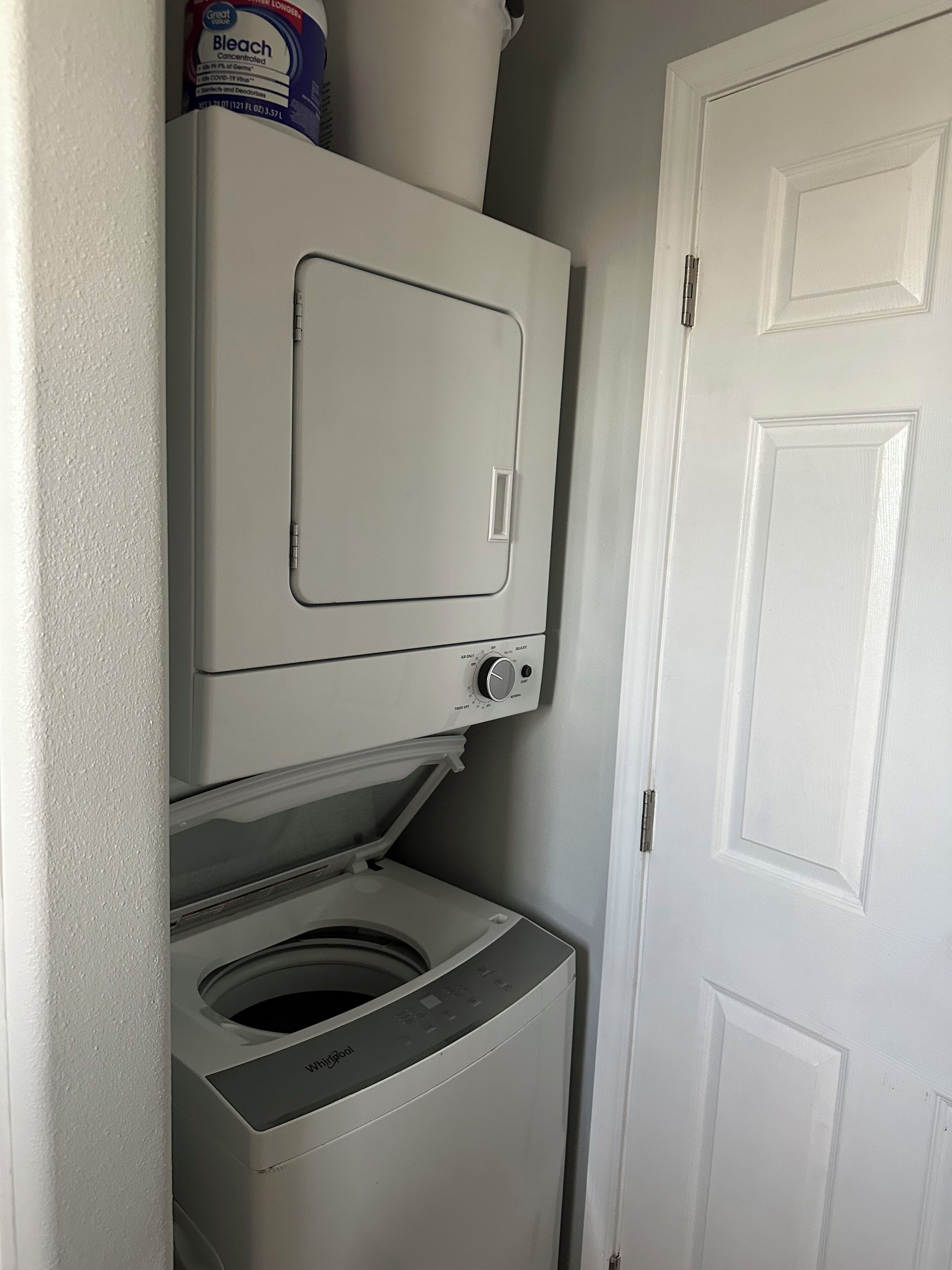 A compact washer and dryer unit with a control panel and a detergent box on top.