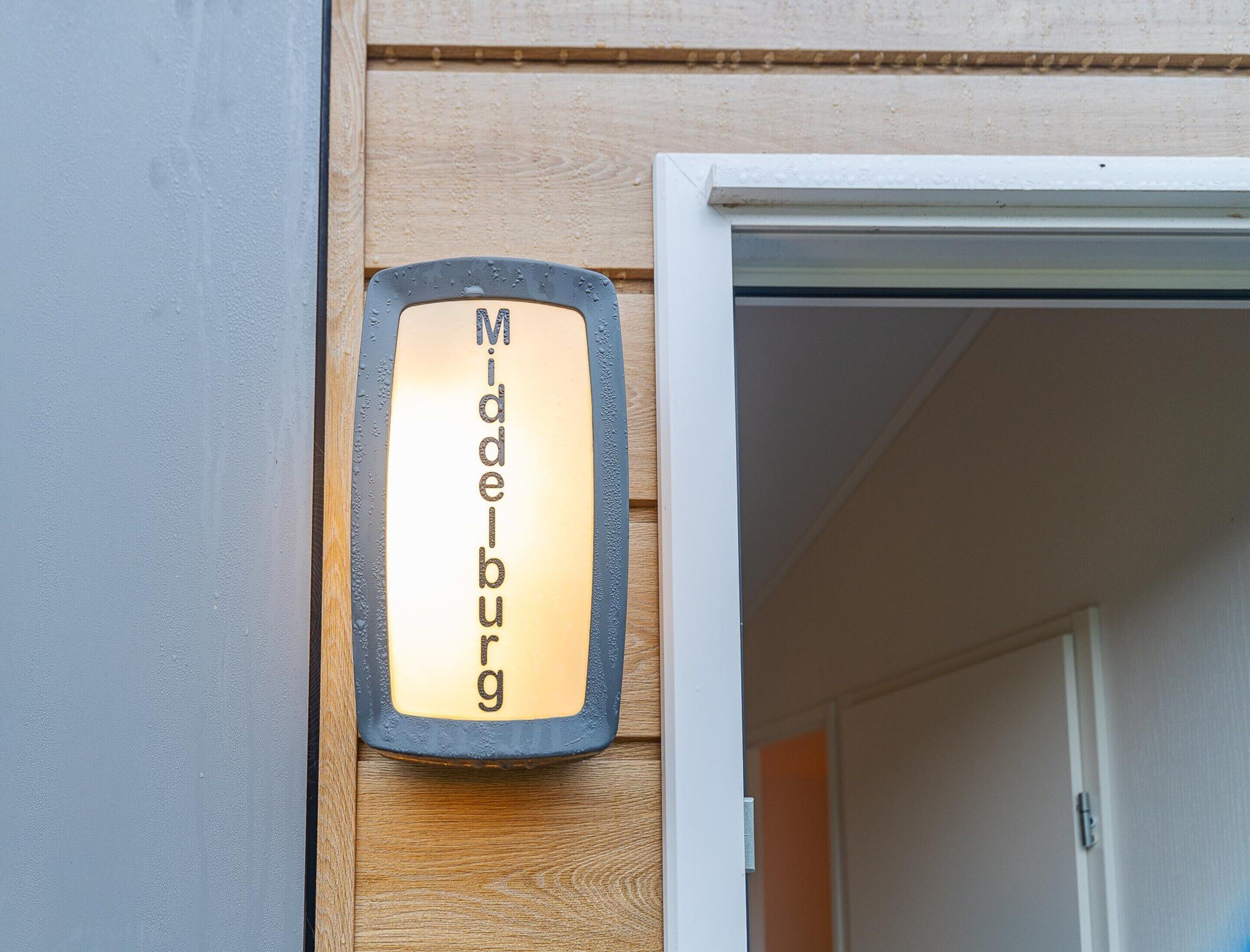 A building entrance with a sign that reads 'Middelburg.'