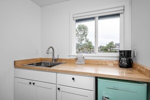 Microwave, coffee/tea maker, dining tables
