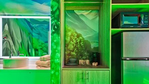 A kitchen with a green theme, a coffee machine, and a microwave. - Pokemon studio w/ Disney shuttle & pool (Kissimmee)