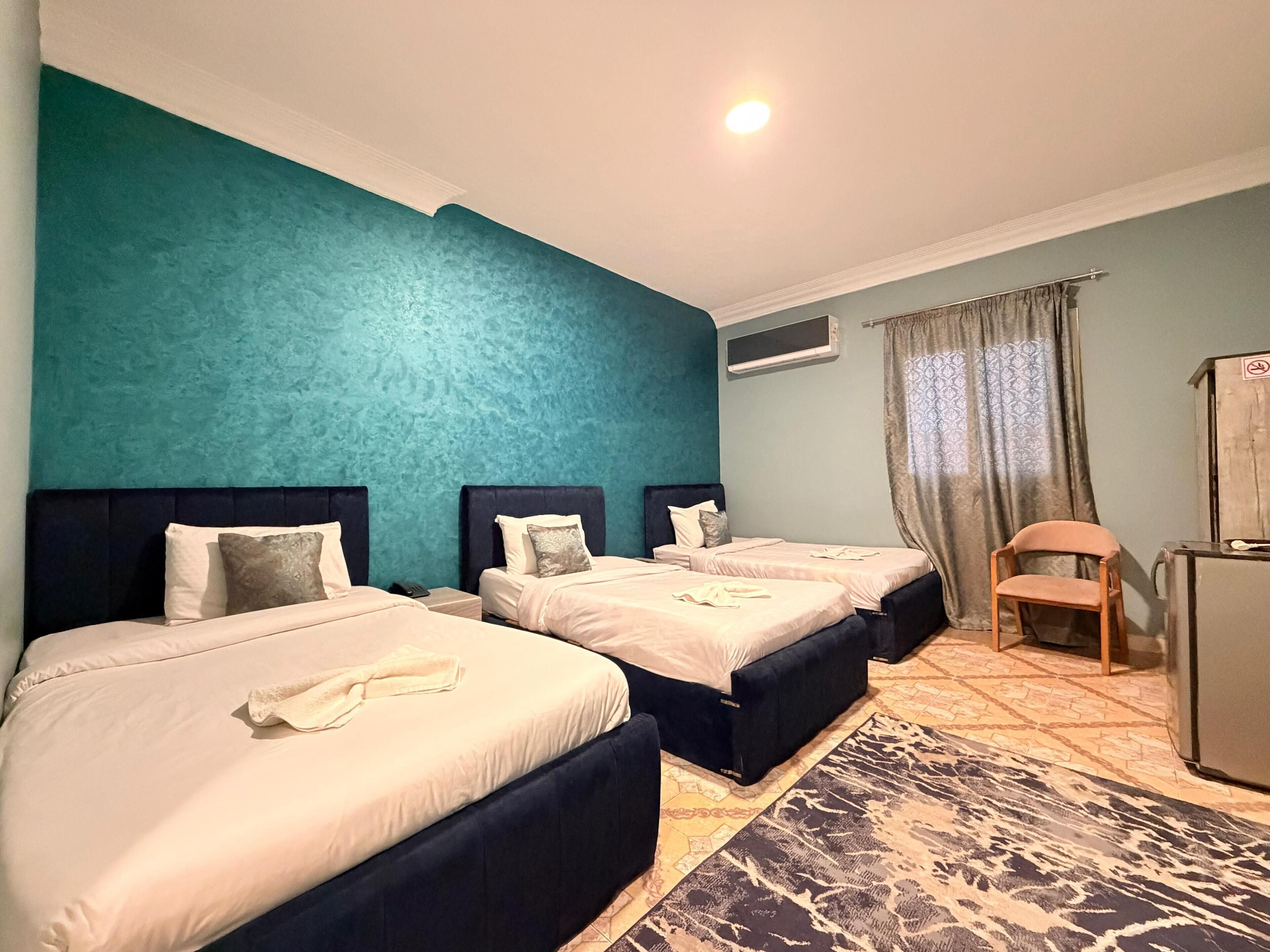 Deluxe Triple Room, City View | In-room safe, desk, soundproofing, iron/ironing board