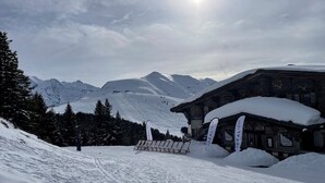 A snow-covered mountain scene with a wooden building labeled "Ideal Restaurant" and a chairlift in the background. - Mountain apartment 5 minutes from the center of Saint Gervais les Bains (Saint-Gervais-les-Bains)