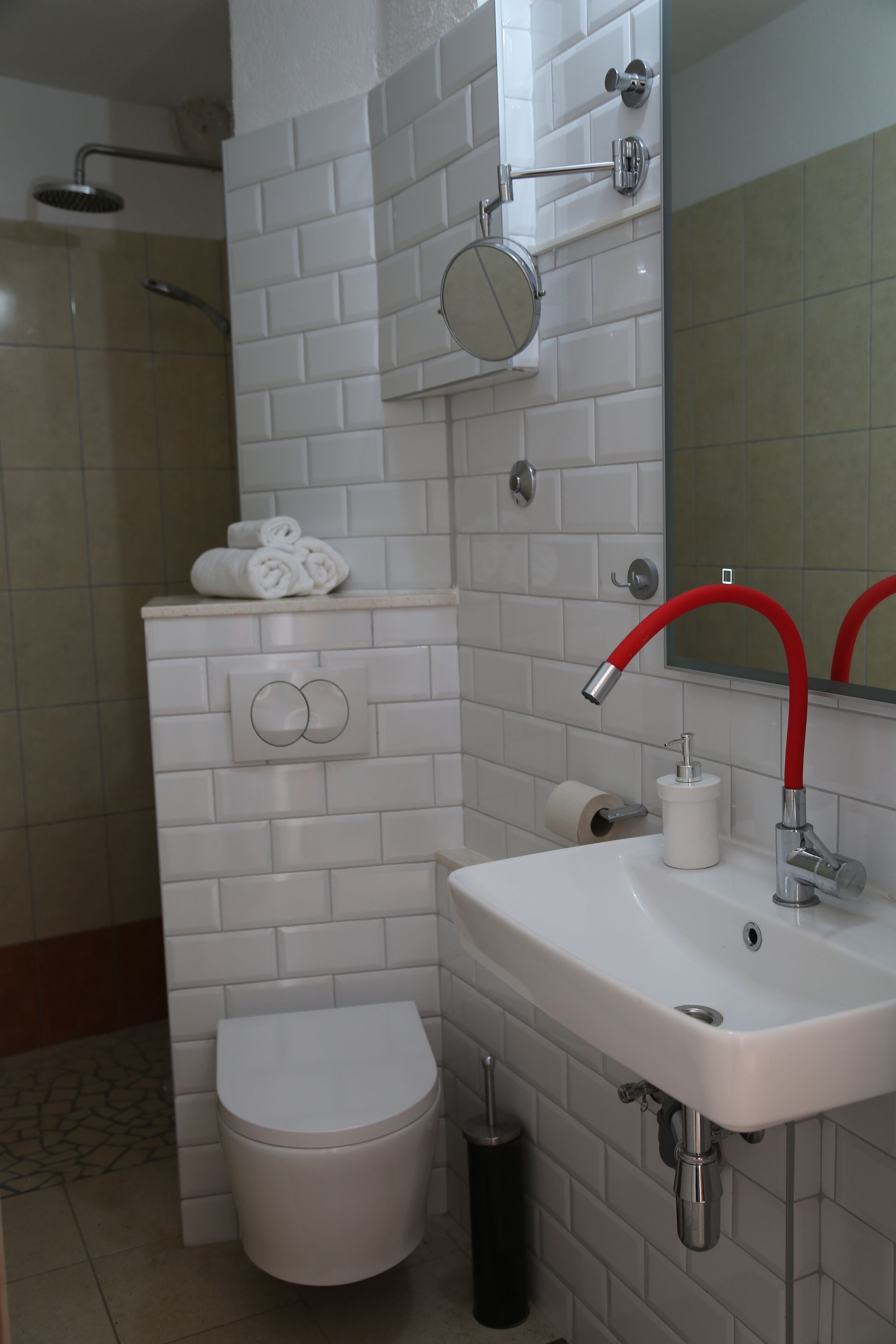 A bathroom with a toilet, sink, and shower.