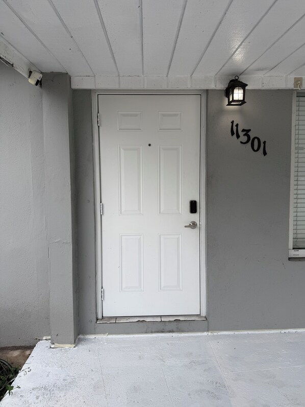 A white door with a number "1301" on the wall beside it. - Terrific 2-bedroom townhome with AC in vibrant Miami (Miami)