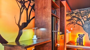 A modern bathroom with wooden cabinetry, a glass shower enclosure, and a tree mural on the wall. - Lion King studio w/ pool & workspace (Kissimmee)