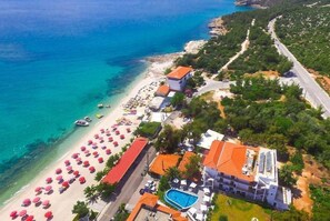 On the beach, white sand, sun loungers, beach umbrellas