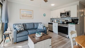 A modern kitchen with white cabinets, a stainless steel microwave, and a black oven. - Steps to the Surf! Top-Floor Condo w/Stunning Ocean View! (Hilton Head Island)