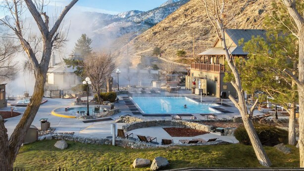 A hot spring resort with a large pool, lounge areas, and a mountain backdrop. - 1 Bedroom Villa, Heated Outdoor Pool and Hotsprings - Gorgeous mountain views (Genoa)
