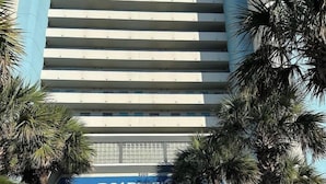 A modern building with a blue and white facade, a prominent Boardwalk sign, and a central fountain. - BOARDWALK BLISS/GREAT LOCATION (Myrtle Beach)