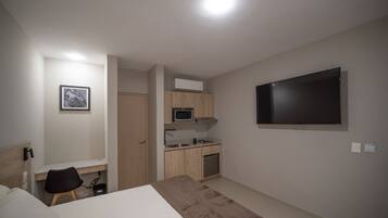 Superior Studio, Patio, Courtyard View | Minibar, in-room safe, desk, laptop workspace