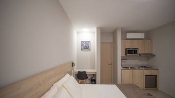 Comfort Room, Patio, Courtyard View | Minibar, in-room safe, desk, laptop workspace