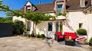 A two-story house with a covered patio area. - Cozy House Near the Castle & Lakeside Leisure Area (Cepoy)