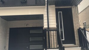 Un edificio de dos plantas con una puerta de garaje marcada con el número 17.