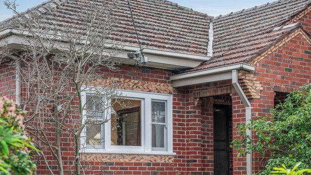 A brick house with a visible front door, a small window, and a pathway leading to the entrance. - Charming Cozy Home Near Local Shops & Chadstone SC (Camberwell)