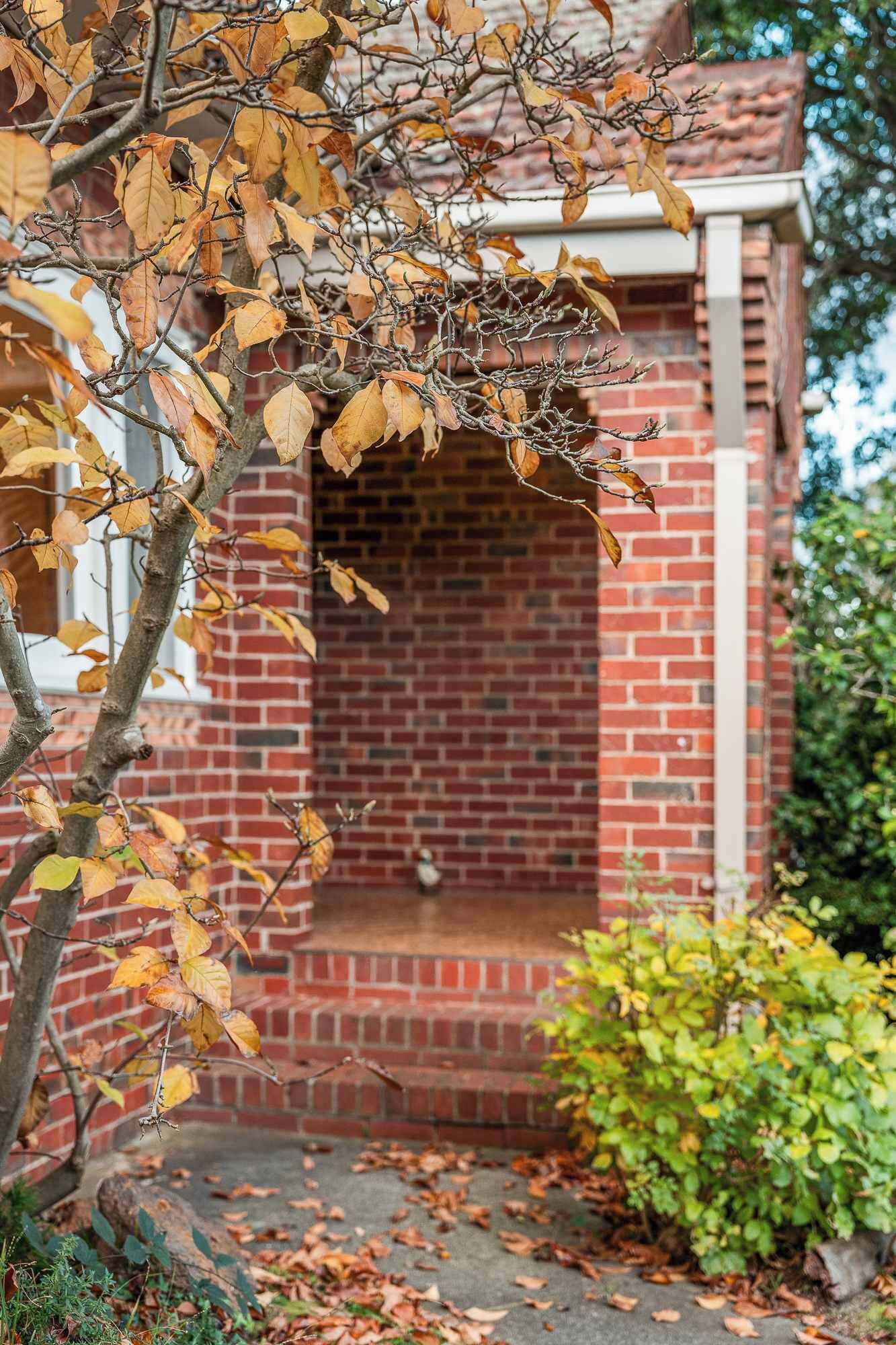 A brick building with a small porch and a door.
