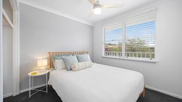 Desk, iron/ironing board, bed sheets