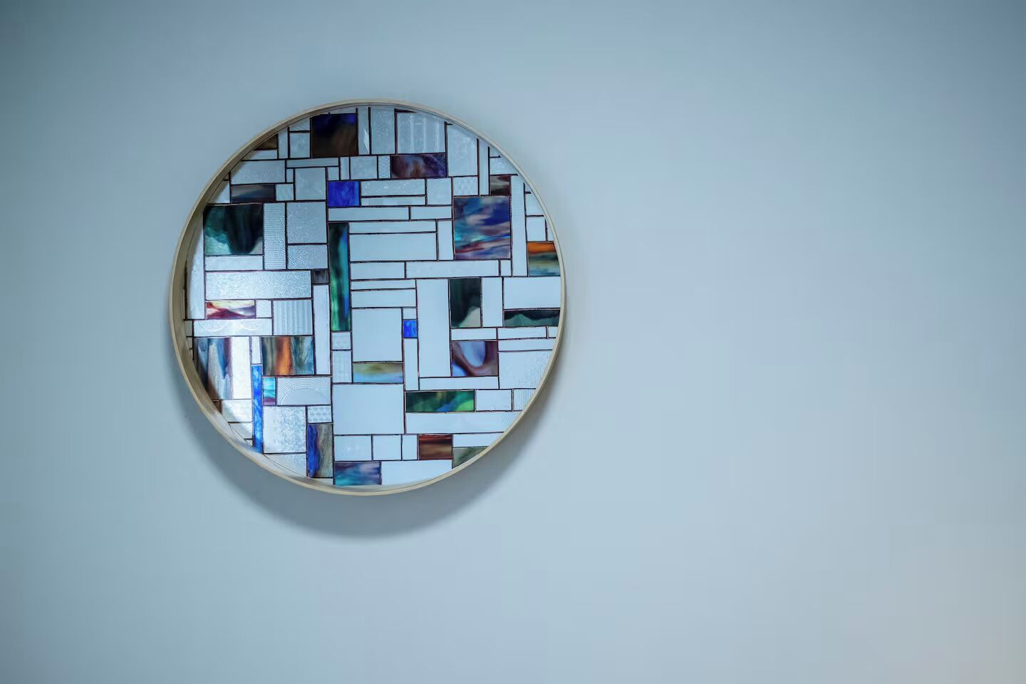 A circular stained glass window with a geometric pattern.