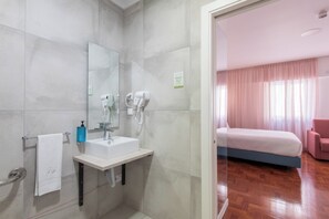 A modern bathroom with a sink, mirror, and hairdryer. - Lisbon Serviced Apartmentos - Campos (Lisbon)