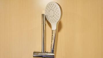 A showerhead with a circular design and a control valve.