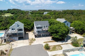 A residential area with three houses, a swimming pool, and a basketball court. - 5BR Private Pool & Spa Walk to Beach & Rec Room (Corolla)