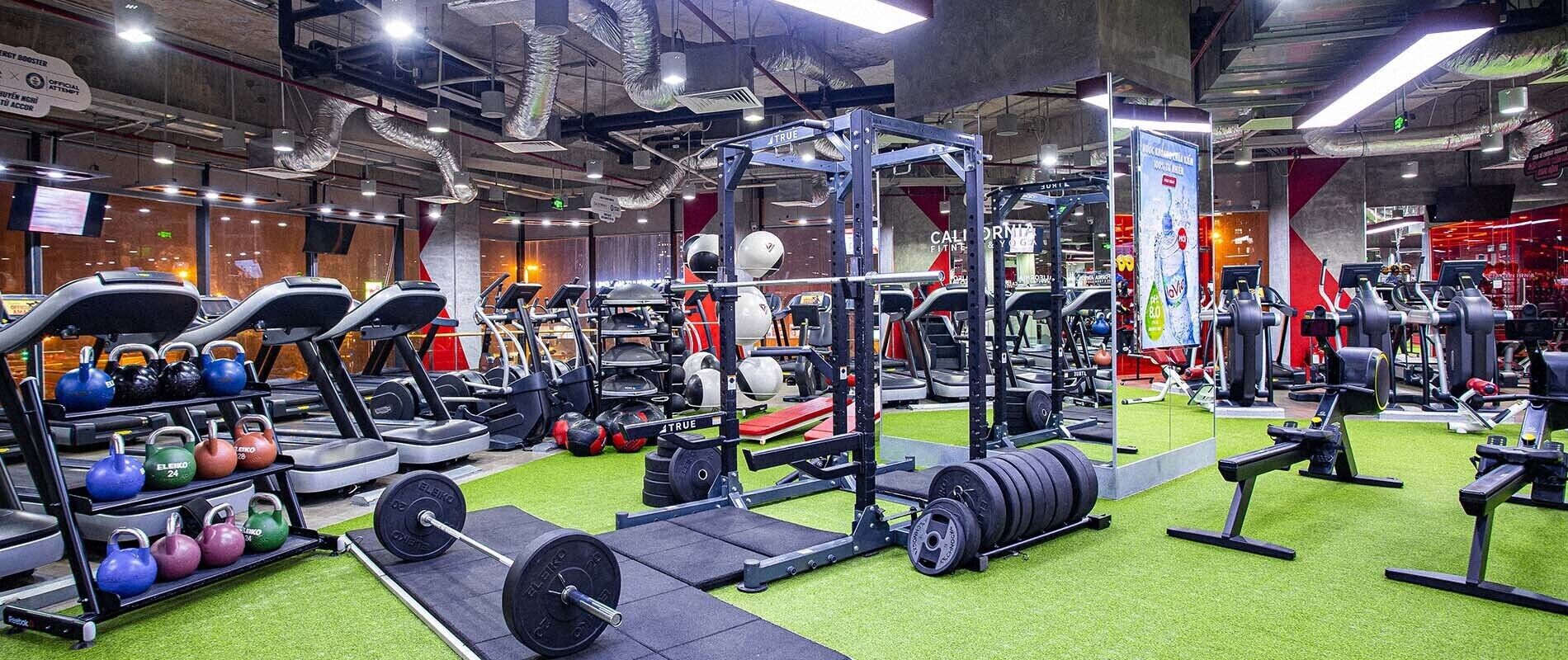 A gym with exercise equipment, treadmills, and weightlifting stations.