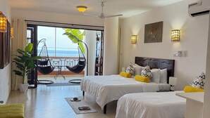 A hotel room with two beds, a balcony, a ceiling fan, and a view of the sea. - Duplex Ocean View 1bedroom Apartment D10 ,Top Floor (Mombasa)